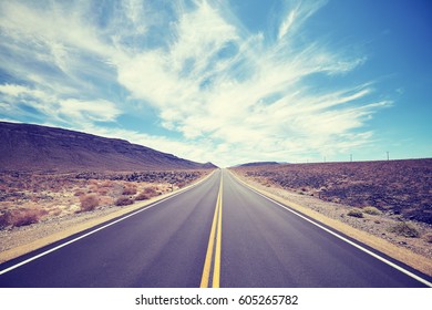 Vintage toned desert road in Death Valley, travel concept, USA. - Shutterstock ID 605265782