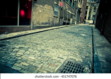 Vintage toned image of Old cobblestone alley in New York City with perspective   - Powered by Shutterstock