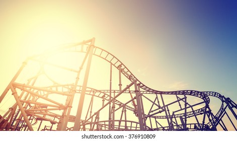 Vintage Toned Picture Of An Amusement Park At Sunset.