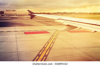 Vintage Toned Plane Wing Above Runway At Sunset, Travel Concept.