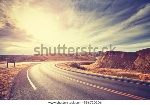 Vintage toned scenic desert highway at sunset,\
travel concept, USA.