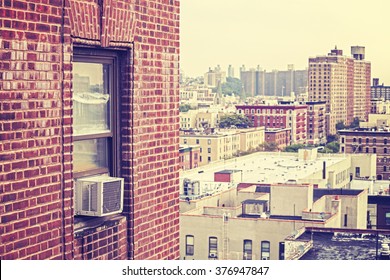 Vintage toned window with external air conditioner unit, Harlem, USA.