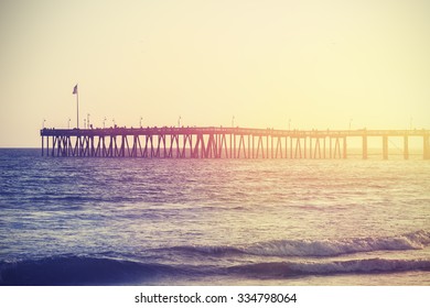 Vintage Toned Wooden Pier On Beach At Sunset, California, USA.