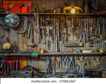 Vintage Tools Hanging On A Wall In A Tool Shed Or Workshop