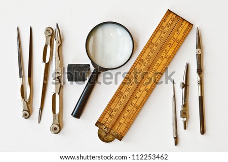 Vintage tools for measurement, drawing, draftsmanship, and graphical works. Isolated on white background.