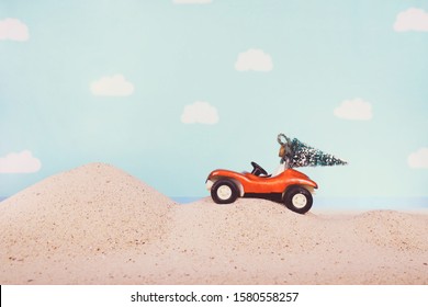 Vintage Toy Dune Buggy Car With A Bottle Brush Christmas Tree Tied To The Top,  At The Beach On Dunes Of Sand