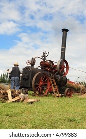 Vintage traction steam engine working in a field at the wheat fest