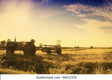 Vintage Tractor In Field Left In The Field At Sunset