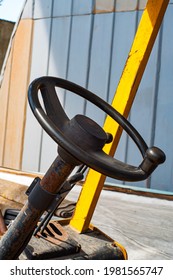 Vintage Tractor. Vintage Tractor Inside A Barn With Mute Colors Showing Seat , Stick Shift And Steering Wheel. Steering Whell