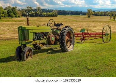 Vintage Tractor And Plow In Field As A Yard Decoration