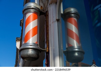 Vintage Traditional Red And White Stripe Barbershop Sign Outside A High Street Barbershop