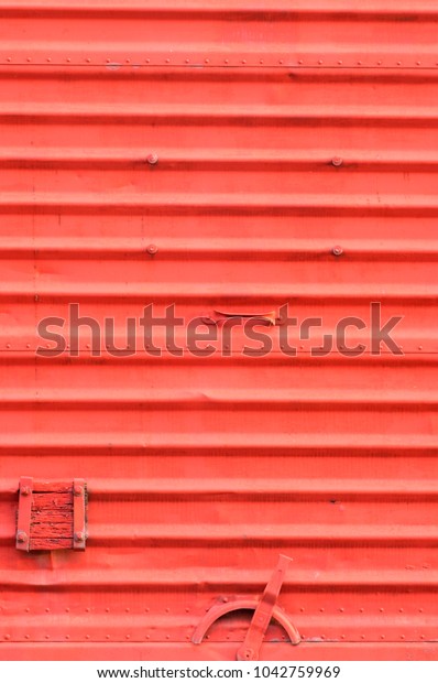 Vintage train carriage door detail with lock and\
intense red texture.