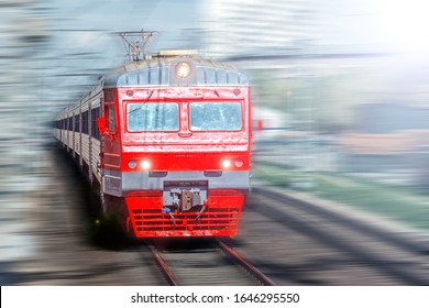 Vintage Train In Motion On High Speed Transportation By Railway Blurred Landscape Against City Railroad Background. Front Wide View Of Red Old Commuter Train. Public Transport Concept