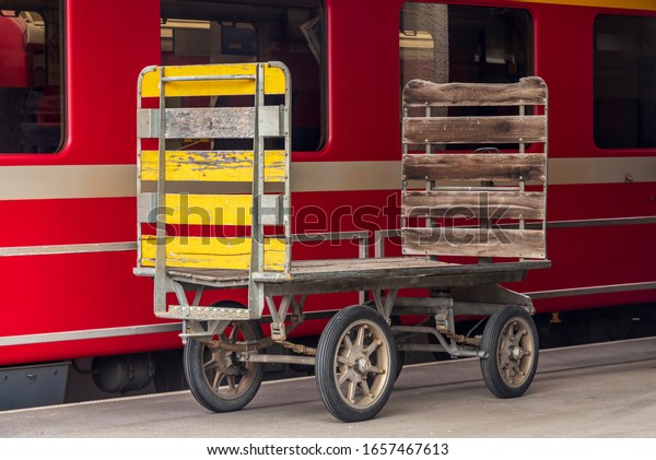 vintage train station\
trolley standing at a platform. Use to carry bags and cargo to and\
from the trains