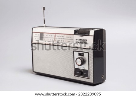 Vintage transistor radio on a gray background.