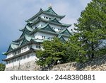 Vintage or travel or architecture background featuring detail of Nagoya castle on cloudy sky  in Nagoya, Japan.