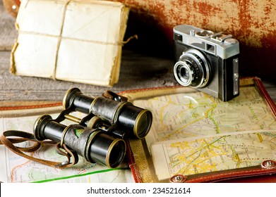 Vintage  Travel Memories Concept. Old Camera, Binoculars, Letters And Map-holder With Map