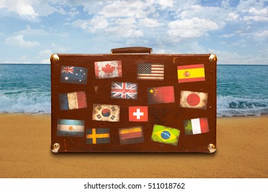 Vintage Travel Suitcase With Stickers On Sea Background