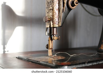 Vintage Treadle Sewing Machine Closeup Of Needle And Bobbin Thread.