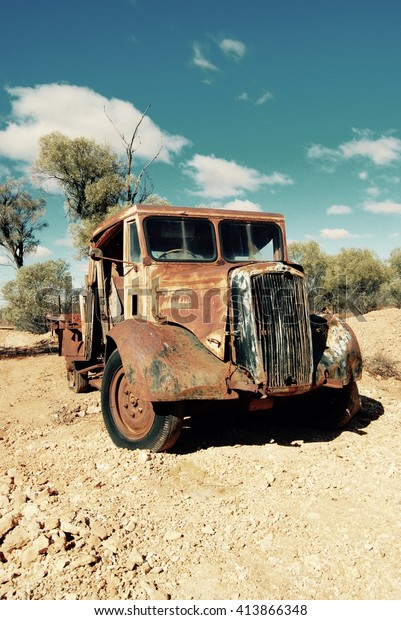 vintage truck on bare
ground with blue sky
