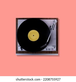 Vintage turntable from 70s with vinyl record on pink background. Top view. - Shutterstock ID 2208755927