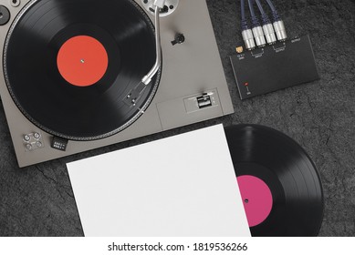 Vintage Turntable With Vinyl LP Record On A Concrete Background. Top View.