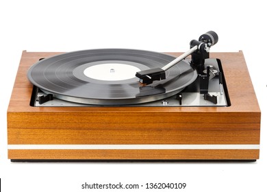 Vintage turntable vinyl record player isolated on white. Wooden plinth. Retro audio equipment.