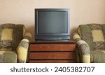 Vintage TV on wooden antique closet, old design in a home.Old black vintage TV. 