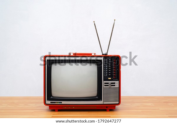Vintage TV set\
isolated. Retro television - Old vintage red television, retro\
technology. Ancient tv\
concept