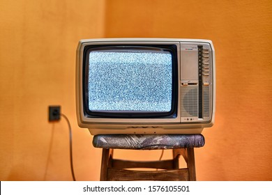 Vintage TV set on a chair in an empty room