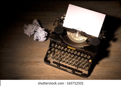 Vintage typewriter and a blank sheet of paper