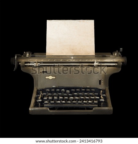 Vintage typewriter with empty sheet of weathered paper on a black background