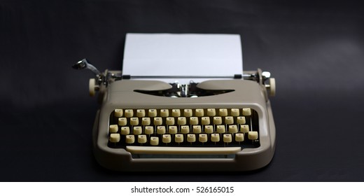 Vintage Typewriter On A Black Background. Creative Writing Concept. Writer. Close Up Of Typewriter Vintage Retro Styled. Typewriter With Paper Sheet. Space For Your Text. 