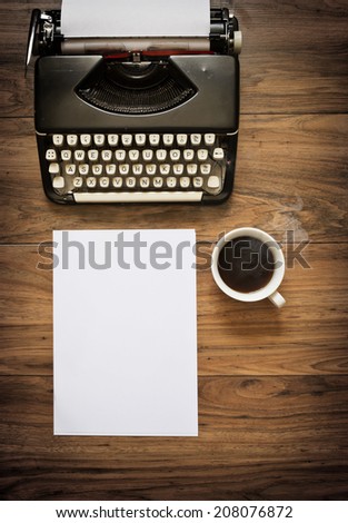 A Vintage Typewriter on a wooden table with coffee and paper