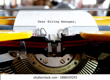 A Vintage Typewriter With Paper Feeding And Text Typed HIRING MANAGER, Concept Of Writing Cover Letter To Apply For Job Position Recruitment