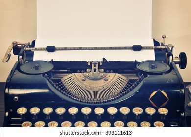 Vintage typewriter with paper on a white background