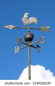 vintage vane to indicate the direction of the wind with the initials of the cardinal points and the steel cock on the top