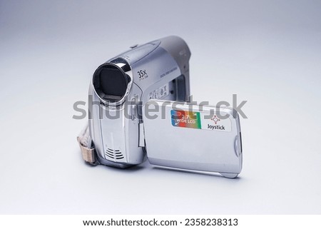 a vintage video camcorder from the 90s with grey background isolated