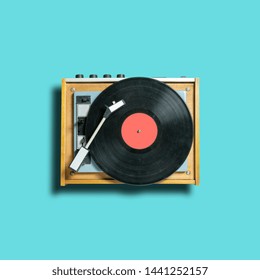 vintage vinyl disc record with coral label on dj turntable on blue background. retro sound technology to play music - Shutterstock ID 1441252157