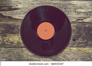 Vintage Vinyl Record On Aged Wood Background