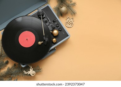 Vintage vinyl record player with Christmas decorations on beige background - Powered by Shutterstock