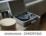 a vintage vinyl record player elegantly positioned on a rustic wooden table. a sense of nostalgia and appreciation for the analog sound, inviting viewers to immerse themselves in the world of classic