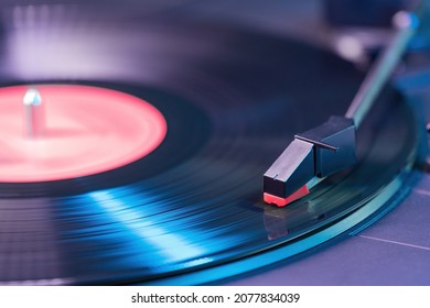 Vintage vinyl record player playing music from LP album.