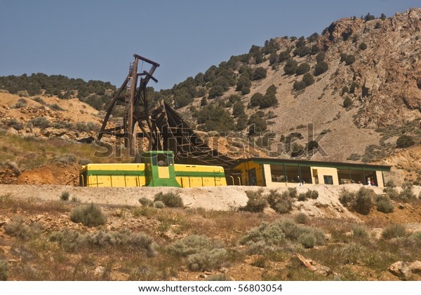 The vintage\
Virginia and Truckee railway in Nevada that runs tourists between\
Virginia City and Gold Hill ( a ghost town) with the ruins of old\
mining equipment in the\
background