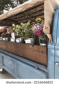 a vintage Volkswagen truck full of beautiful flowers ready to be turned into custom bouquets 
