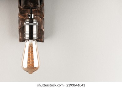 Vintage Wall Lamp To Illuminate The Terrace. Antique Lamp With Edison Bulb. The Concept Of Saving Energy Or Lack Of Ideas. Turned Off Lamp On A Light Background.