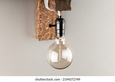 Vintage Wall Lamp To Illuminate The Terrace. Antique Lamp With Edison Bulb. The Concept Of Saving Energy Or Lack Of Ideas. Turned Off Lamp On A Light Background.