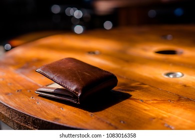 The Vintage Wallet On The Wood Table.Dramatic Light.