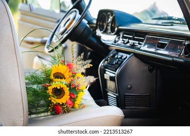 Vintage wedding car with lovely wedding bouquet full of roses and sunflowers - Powered by Shutterstock