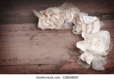 Vintage wedding dress flowers on a wooden backgroung